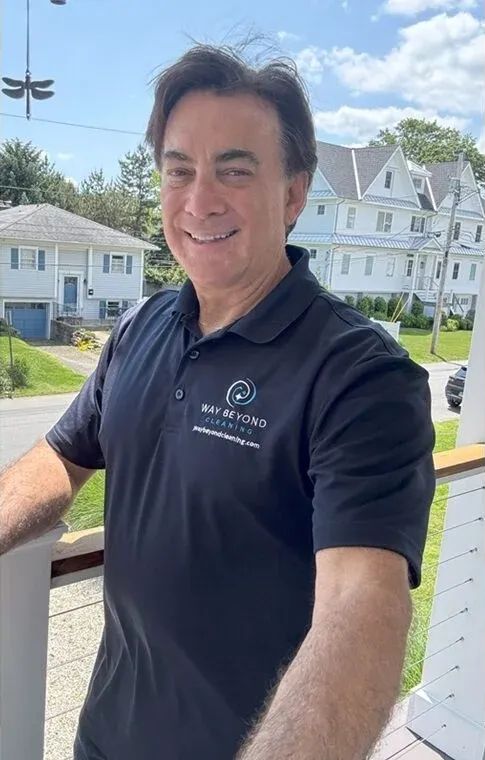 Rich, owner of Way Beyond Cleaning, in a company shirt on a porch in Fairfield County